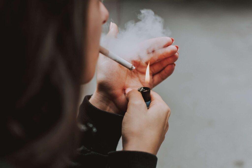 Person lighting a cigarette
