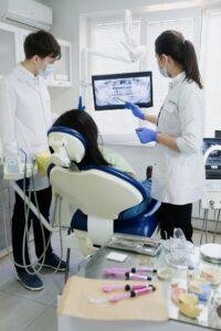Dentists reviewing wisdom tooth X-ray before extraction in Richmond Hill