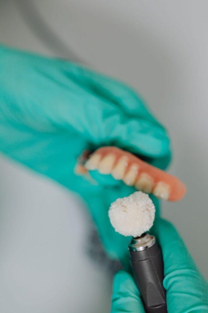 Close-up of a denture being polished after a professional repair