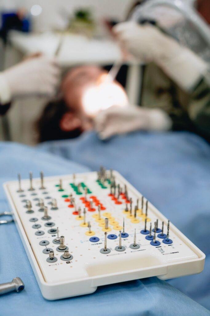 Dental implant kit with dentist treating a patient
