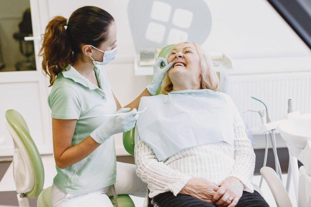 Dentist examining a senior patient for denture sore spots