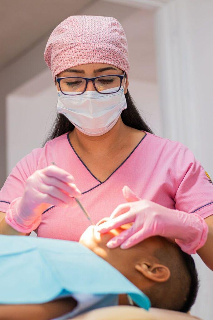 Dentist examining a patient mouth during an emergency visit