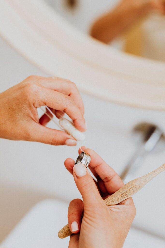 Woman flossing her teeth in front of a mirror