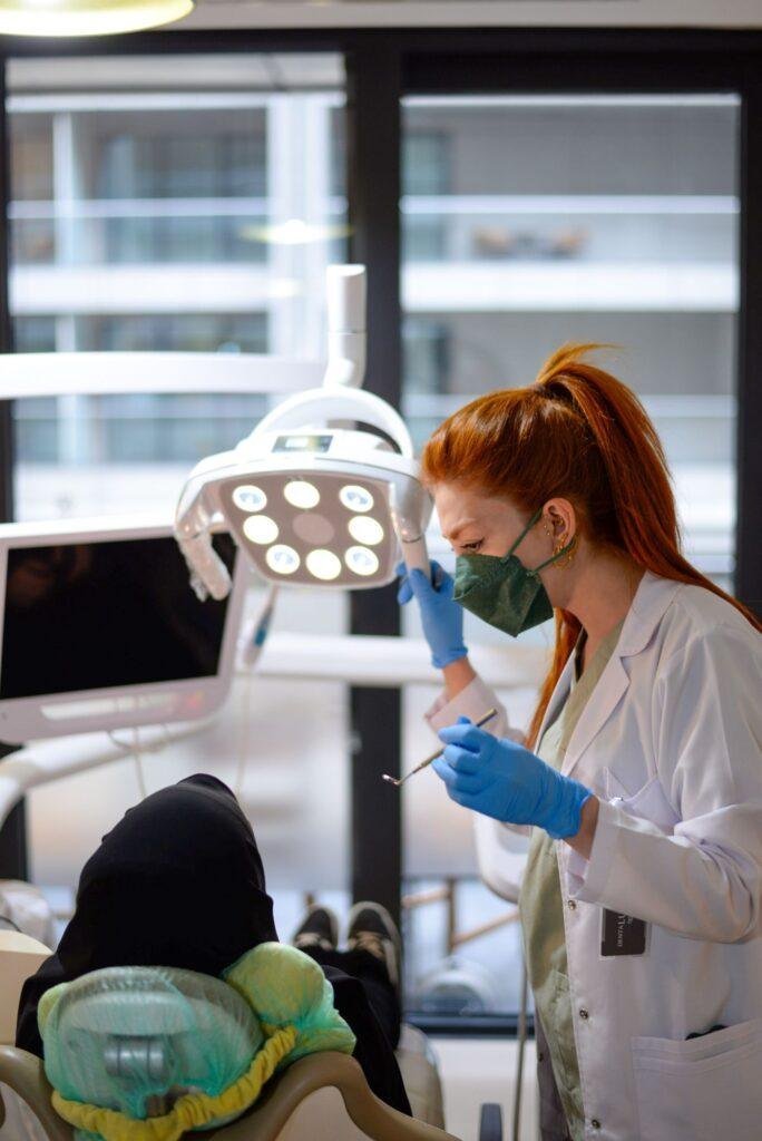 Female dentist performing a dental procedure on a patient