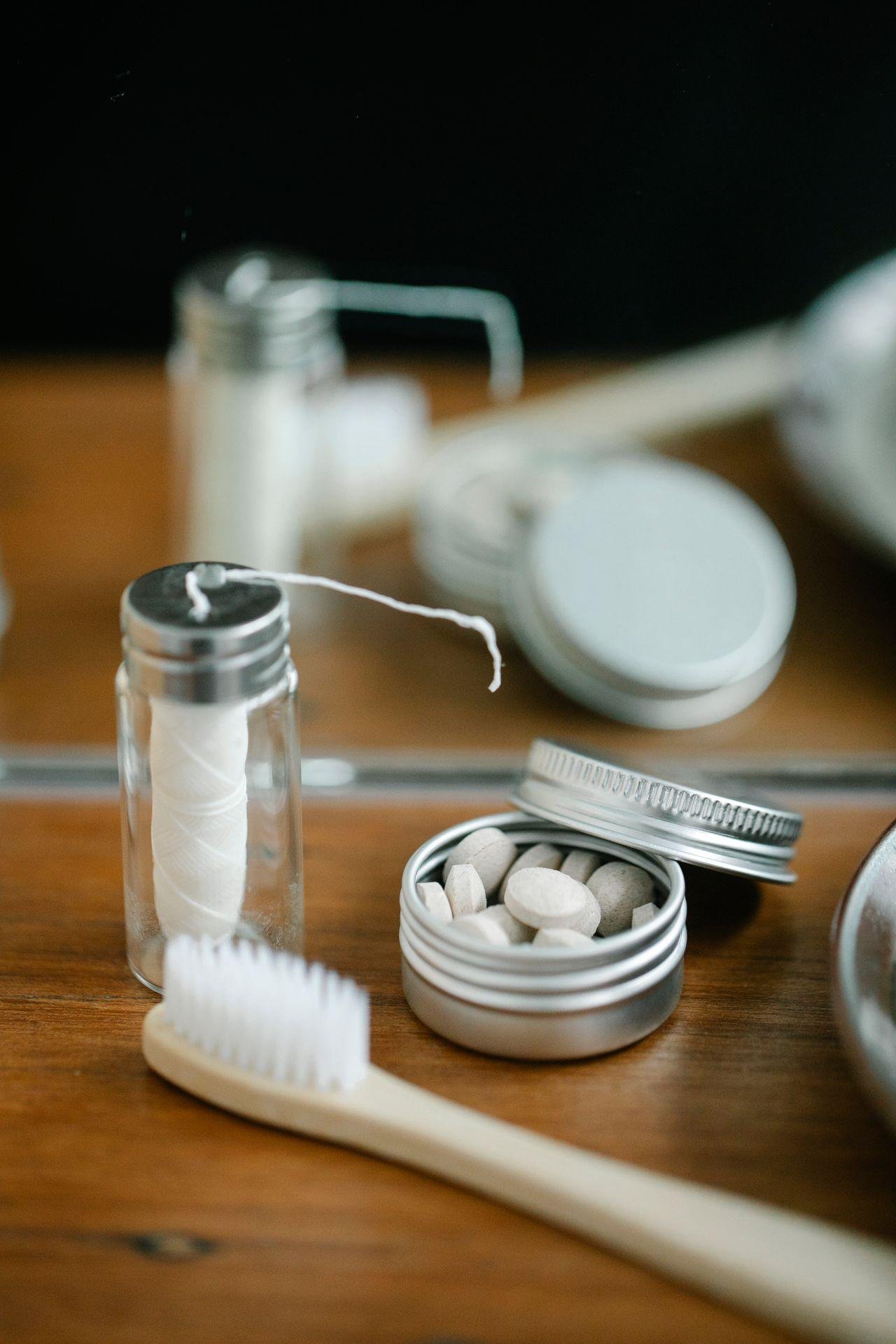Dental floss, toothbrush and toothpaste on a bathroom counter