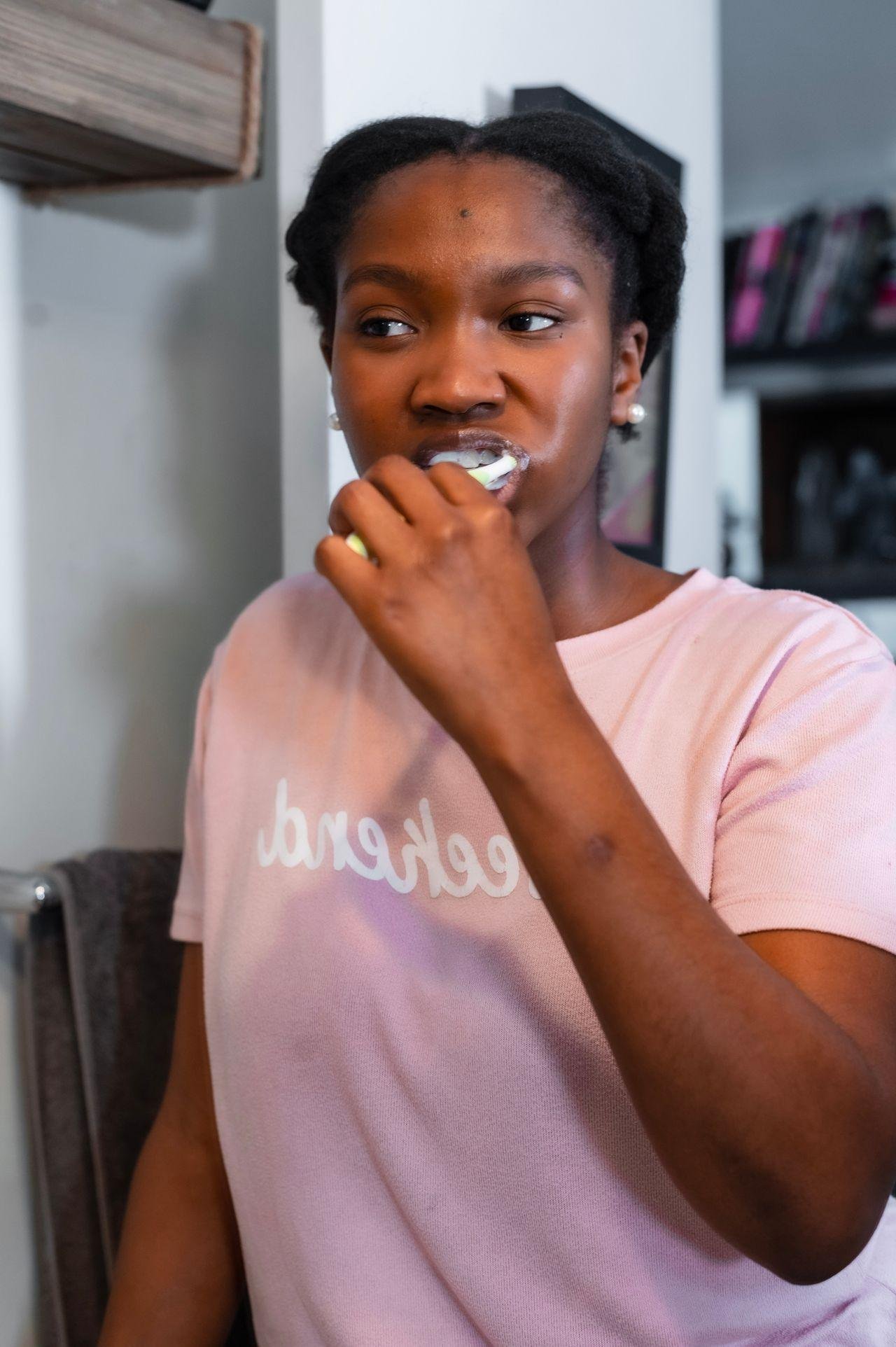 Woman brushing her teeth in the morning