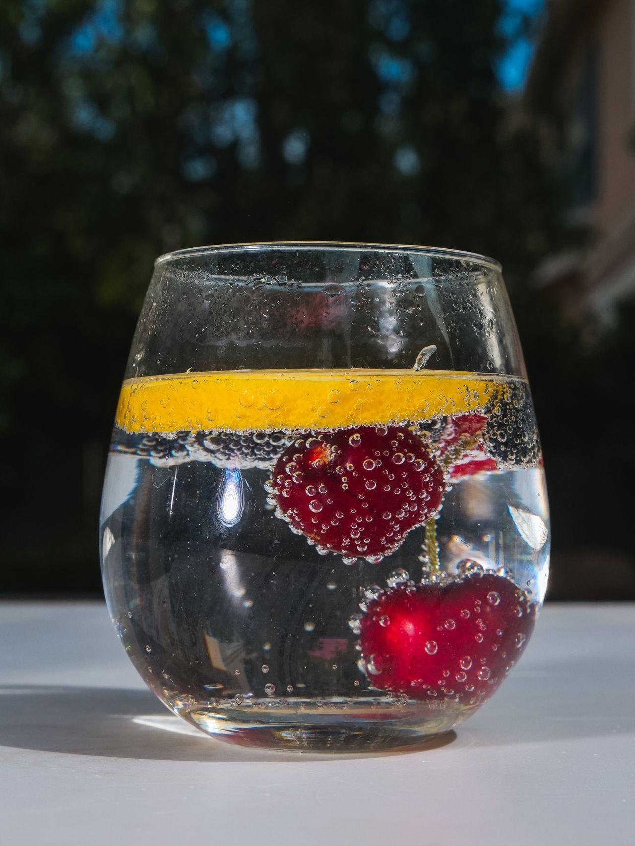 Berries floating in a glass of sparkling water