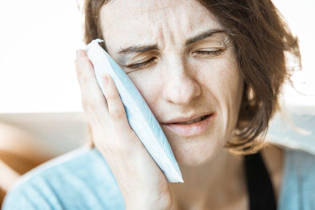 Person with mouth discomfort from a denture sore spot
