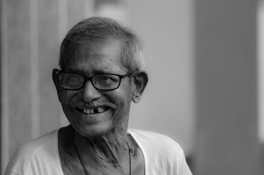 Portrait of a smiling older man with healthy facial support