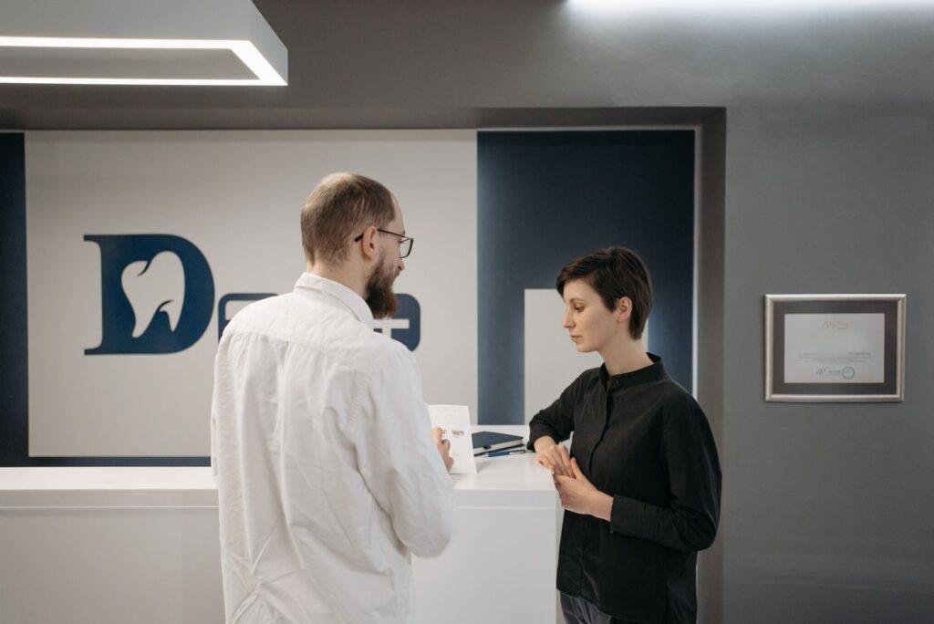 Dentist consulting a patient at a modern dental clinic