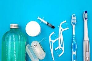 Mouthwash and oral hygiene products on a blue background