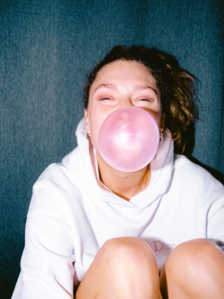Smiling woman chewing gum comfortably